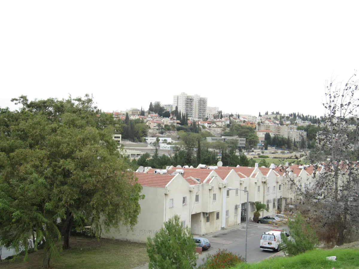 View from Givat Sharett across terraced red-roofed houses towards older Beit Shemesh on the opposite hill