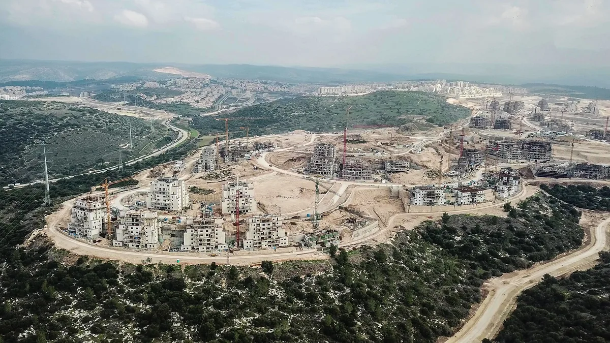 Aerial view of Ramat Beit Shemesh Daled under construction in 2020, with new apartment blocks and cranes on a hilltop